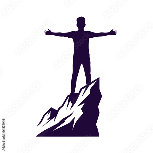 Man on mountain top with arms spread wide in victory