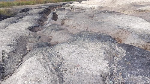 Tailings and waste rock in a mined open pit brown coal quarry. Heavy erosion and dunes of fine sand mixed with coal.
