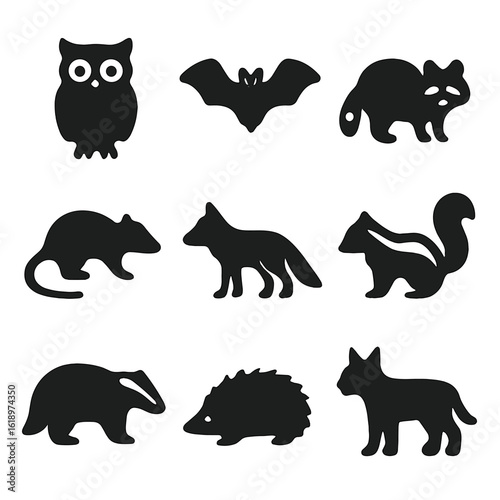 Nocturnal Animal Icons. Solid, filled icon set of nocturnal animal silhouettes: owl, bat, raccoon, possum, fox, skunk, badger,