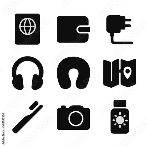 Travel Essentials Icons. Solid, filled icon set of travel essentials: passport, wallet, phone charger, headphones, travel pillow,