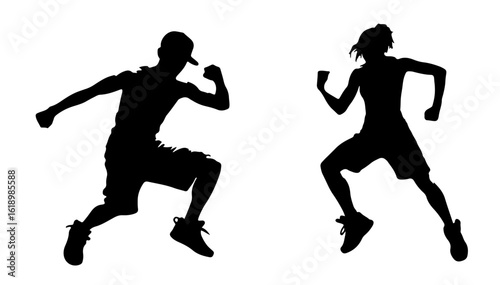 Silhouettes of man and woman performing capoeira kick in dance pose
