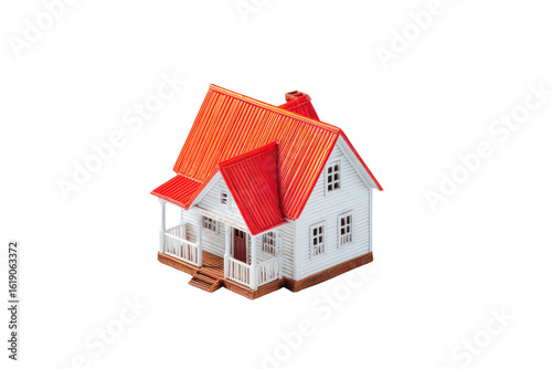 Miniature house model, with a red corrugated roof and white walls, sits centered on a black background.?Porch and small windows are visible