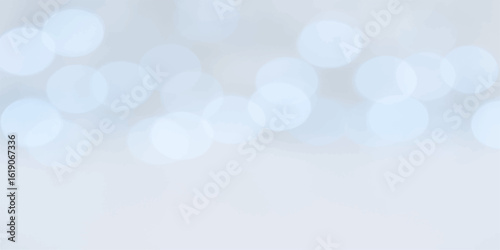 Abstract glowing bokeh background in pastel blue tones with soft circular highlights