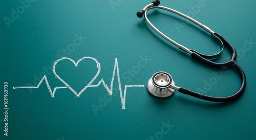 Stethoscope and Heartbeat Chalk Drawing on Green Background, Medical Concept
