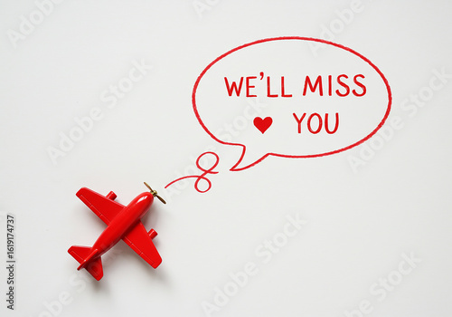 Farewell gift for a colleague leaving, a red toy airplane with a speech bubble that says We'll Miss You, conveying heartfelt goodbyes, and best wishes