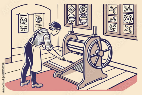 Artist operating a printing press in a studio.