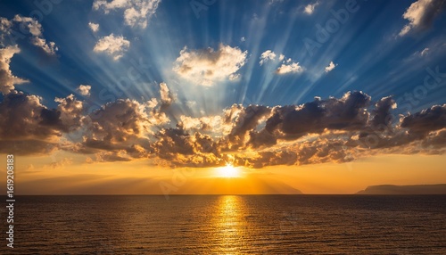dramatic sunset with golden light shining through clouds creating beautiful crepuscular rays in sky the sun s rays pierce the cloud cover illuminating the scene with a warm ethereal glow