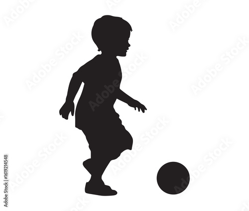 Black silhouette of a child kicking a ball.