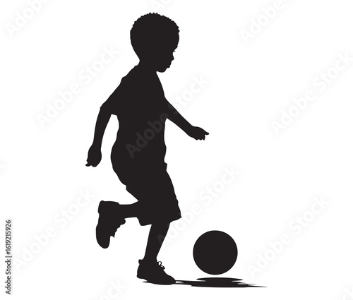Black silhouette of a child kicking a ball.