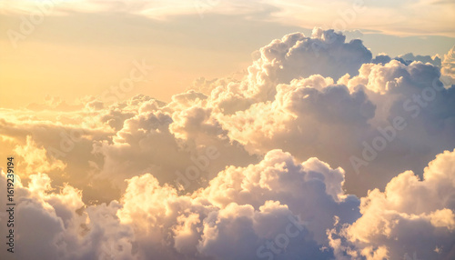 Cloudscape Serenity: Witness the majestic beauty of a cloudscape, where billowing clouds are illuminated by the golden sunlight, evoking feelings of peace and wonder.