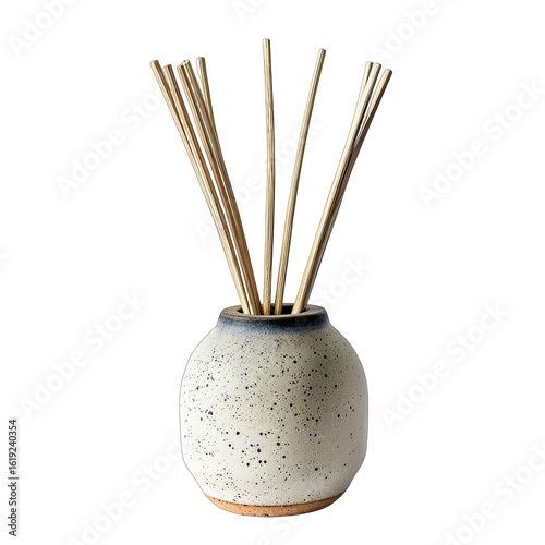 Small, round, speckled ceramic diffuser with light beige and dark speckles.  Wooden reeds extend upward