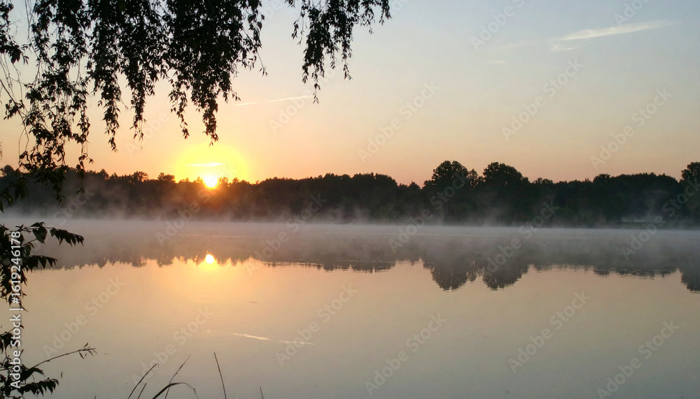 Serene Lake at Sunrise: Captivating moment where the rising sun casts its golden light over a tranquil lake, creating a breathtaking reflection mirroring the dawn's beauty. Serene Lake at Sunrise: Captivating moment where the rising sun casts its golden light over a tranquil lake, creating a breathtaking reflection mirroring the dawn's beauty.