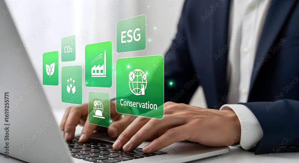 Fototapeta premium Executive types on laptop with ESG icons overlay. Background office setting. Concept sustainability