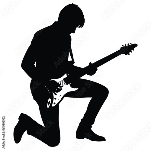 Black silhouette of a male guitarist playing electric guitar on knees