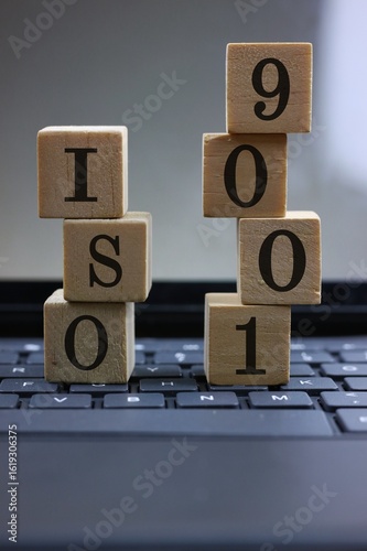 ISO 9001 Quality Standard Blocks Displayed on Laptop Keyboard Surface