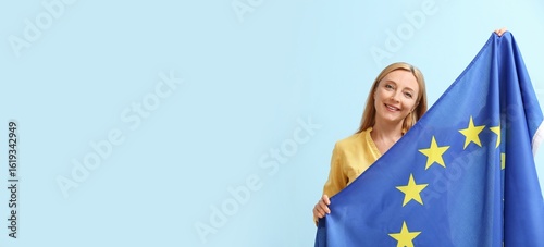 Mature woman with flag of E...