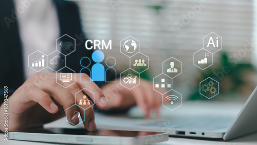Businessman using CRM system with AI-powered tools for customer relationship management, sales analytics, and digital marketing strategy in a modern office environment.