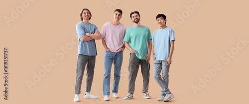 Group of young men on beige...