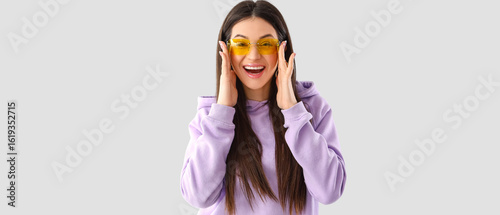 Stylish young woman in lila...