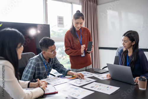 Asian business woman Application Designers presenting trending products report mobile application planning process development software design project ux Graphic designer