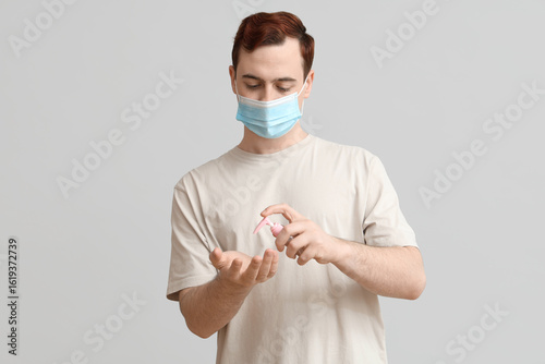 Young man with sanitizer on...