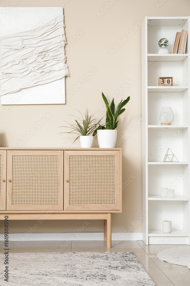 Fototapeta premium Wooden chest of drawers and shelving unit in interior of modern living room