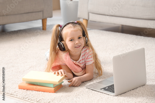 Cute little girl in headpho...