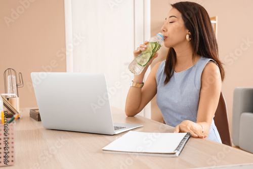 Young Asian woman drinking ...