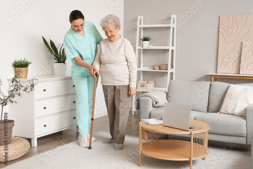 Senior woman with stick and...