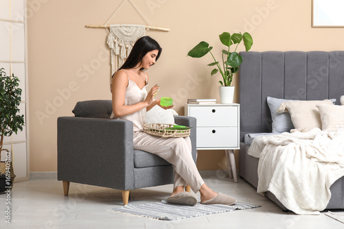 Beautiful young woman using...