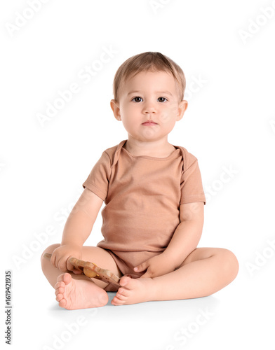 Adorable baby boy sitting c...