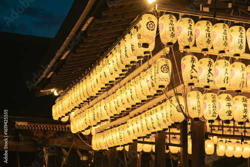 a hundred lit paper lanterns in a temple in Japan