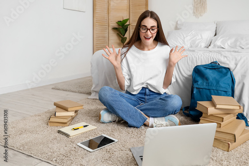 Happy female student with b...