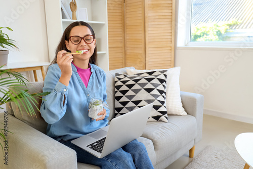 Young woman with laptop and...