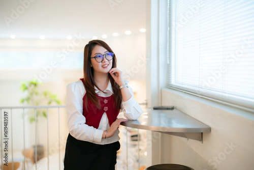 Free Download Portrait of beautiful happy Smiling asian woman relaxing sitting in cafe interior in coffee shop background - GFXLoad