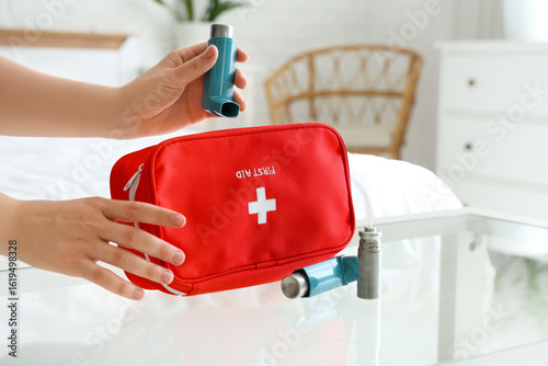 Woman taking modern inhaler...