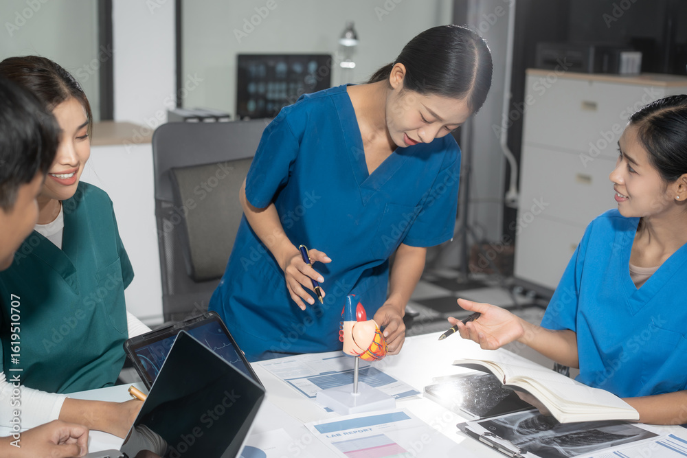 Obraz premium Hospital administrators and physicians sit at a conference table, analyze medical reports, and work as a team to manage healthcare, integrate medical technology, and process clinical decisions