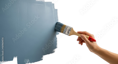 Fototapeta Naklejka Na Ścianę i Meble -  Hand holding paintbrush applying blue paint to textured surface painting transparent background