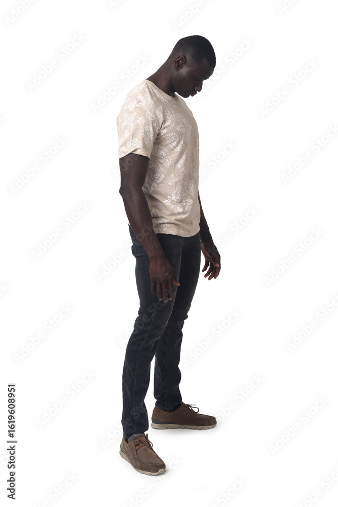 Naklejka premium side view of a man standing and looking down on white background