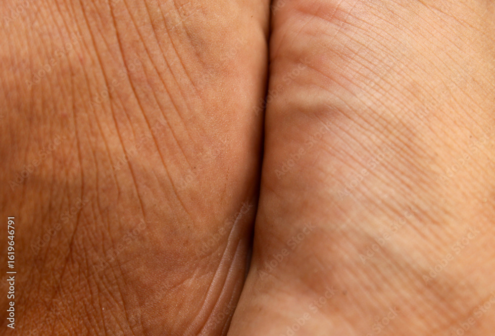 Naklejka premium The skin texture of Asian men's feet is tan or brown. Men's feet skin background