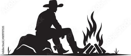 Silhouette of cowboy sitting by campfire