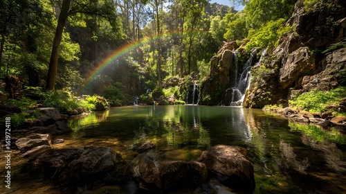 Rainbow over clear lake in forest.