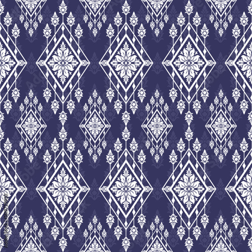 Seamless white floral and geometric pattern Intricate diamonds and blossoms repeat on a deep blue background Symmetrical