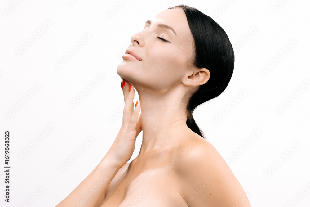 Beautiful woman with clear skin gently touching her neck, showcasing a serene expression against a white background, emphasizing beauty and self-care in a minimalist setting with copy space Beautiful woman with clear skin gently touching her neck, showcasing a serene expression against a white background, emphasizing beauty and self-care in a minimalist setting with copy space
