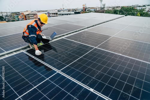 Technician performs maintenance on solar panels on a rooftop in an urban area during the day