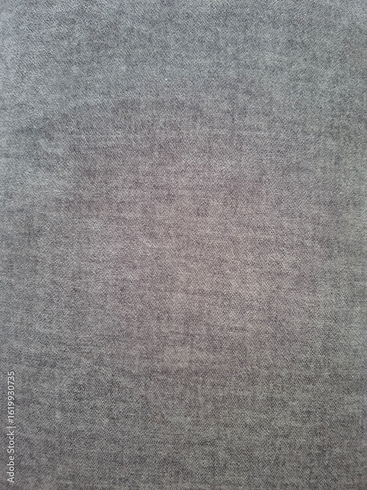 Fototapeta premium Fabric texture close-up – Detailed view of a grey textile surface with visible fibers and woven pattern