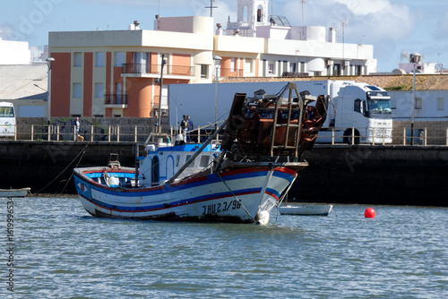 White motorboat floating on water near ria formosa natural park, portugal