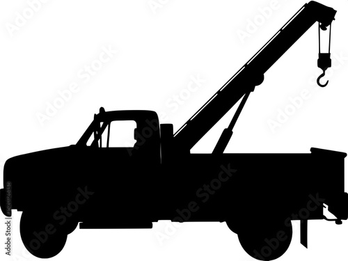 A minimal, schematic side view of a tow truck in black and white. The tow arm is extended slightly behind the cab, with geometric shapes used to represent mechanical parts. The vehicle is static, and 