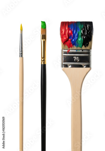 Three artist's paintbrushes with wooden handles and metal ferrules, featuring dabs of vibrant yellow, green, red, blue, and black paint, standing upright against a transparent studio background with