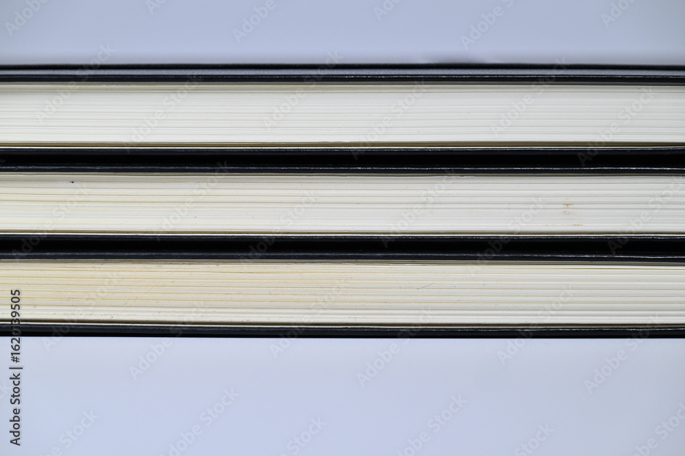 Fototapeta premium Stacked hardcover book page edge texture background